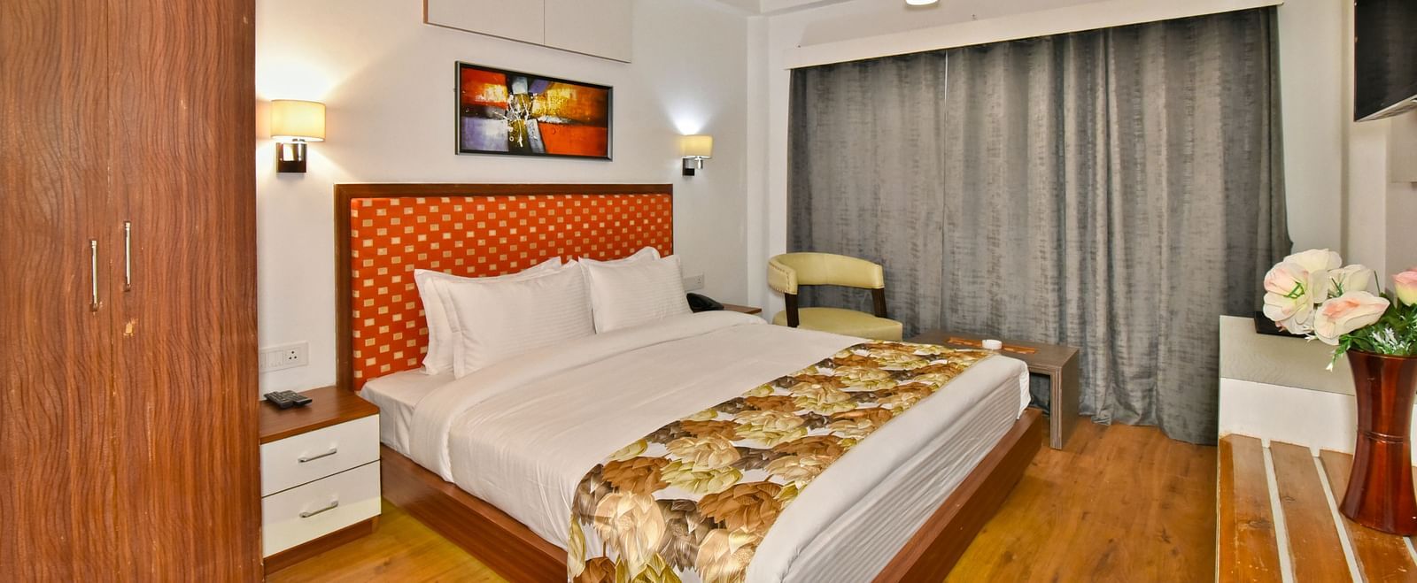 Bedroom with a wooden wardrobe next to it at DLS Hillcrest Resort, Shimla.
